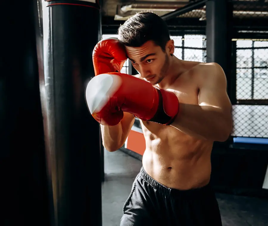 sportsman in red boxing gloves with a naked torso
