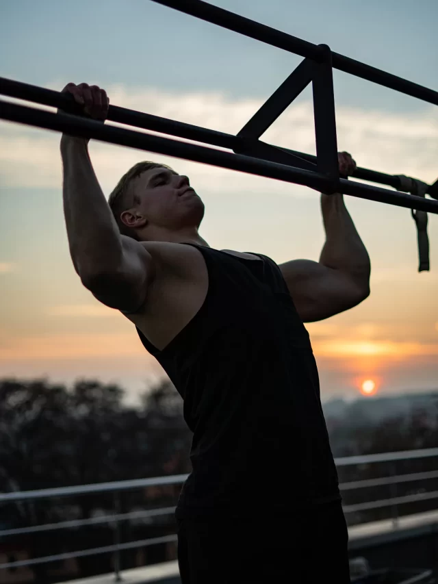 muscular-man-doing-pullups-sunset-sky-background-concept-willpower-motivation-passion